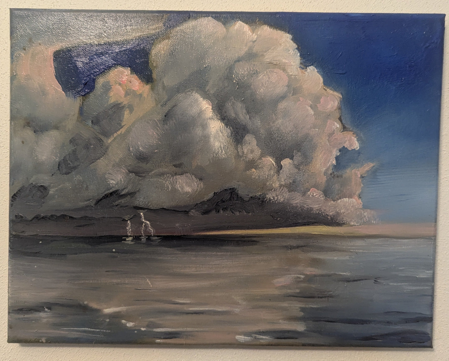 Painting of a large cloud over water on a beige wall