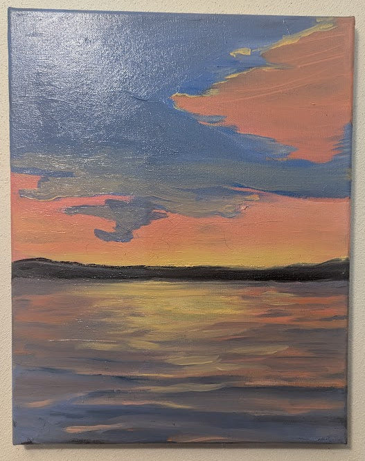 Painting of a sunset over water on a beige wall